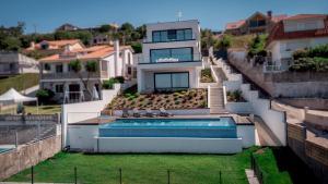 a house with a swimming pool and a house at Chalet Mirador da Pinela in Cangas de Morrazo