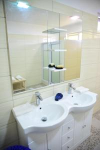 a bathroom with a white sink and a mirror at Casa Rosa in Flic-en-Flac