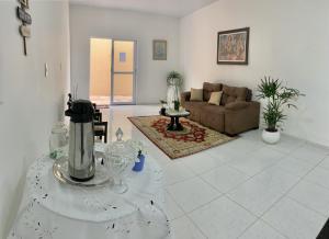 a living room with a couch and a table at Amigos da Praia - Nova Administração in Fortaleza