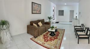 a living room with a couch and a rug at Amigos da Praia - Nova Administração in Fortaleza