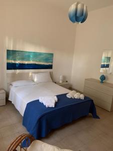 a bedroom with a bed with two towels on it at La Villetta al Mare in Porto Cesareo