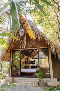 an outdoor patio area with a canopy over the top of it at Mandala Eco Villas in La Libertad