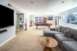 a living room with a couch and a table at Beach Resort Home with Ocean Views Jacuzzi & Sauna! in San Diego