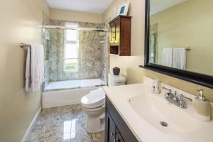 a bathroom with a sink and a toilet and a shower at Beach Resort Home with Ocean Views Jacuzzi & Sauna! in San Diego +57 photos