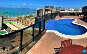 a view of a swimming pool on top of a building at Vacanze - Port Ville III in Maceió