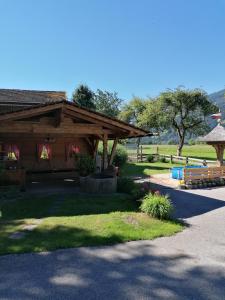 a pavilion with a picnic table and benches in a park at Uhlerhof in Stumm