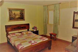 a bedroom with a large bed and a window at HOTEL TAYRONA IMPERIAL in Bucaramanga