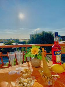 a table with a bottle of alcohol and glasses on it at B&B Marilyn's House in Gragnano +10 photos