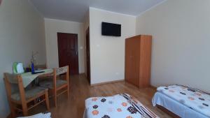 Postel nebo postele na pokoji v ubytování Rodzinna Przystań