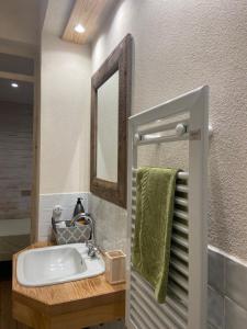 a bathroom with a sink and a mirror at Al Riccio in Cocconato