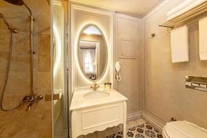 a bathroom with a sink and a shower at Meroddi Barnathan Hotel in Istanbul +109 photos