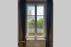 a window in a room with a radiator in front at Le Clos de l'Eglise - Blanche in Giverny +14 photos