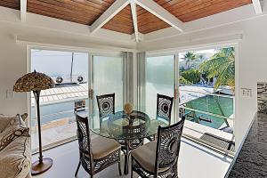 a dining room with a glass table and chairs at Summerland Canal in Summerland Key