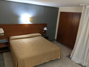 
a bedroom with a bed and a lamp at Torrejoven in Torrevieja
