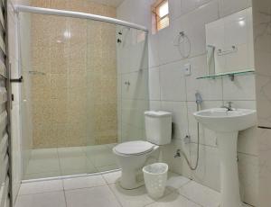 a bathroom with a toilet and a shower and a sink at Amigos da Praia - Nova Administração in Fortaleza +17 photos