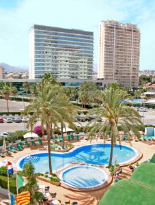 an overhead view of a pool with palm trees and buildings at AR Roca Esmeralda & SPA Hotel in Calpe