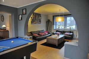 a living room with a pool table in it at Gite Au Phil du Temps in Érezée