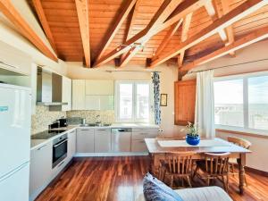 a kitchen with a table and chairs in a room at Seaview Kaposantes Apartments in Lefkada
