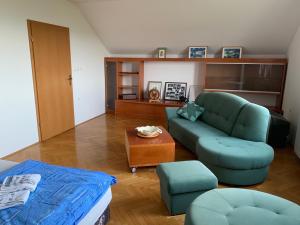 sala de estar con sofá azul y mesa en Wine House, Zidanica Gruden, en Novo Mesto