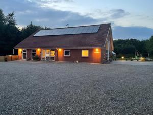 a house with solar panels on top of it at Emda Country living close to Legoland in Billund