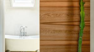 a bathroom with a tub and a sink and wood at Santa Lucia Maccarese - Residenza Agricola in Maccarese