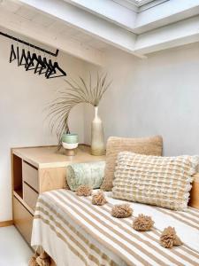 a bedroom with a bed and a dresser with a plant at Santa Lucia Maccarese - Residenza Agricola in Maccarese