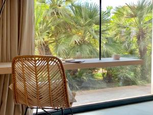 a wicker chair sitting in front of a window at Santa Lucia Maccarese - Residenza Agricola in Maccarese