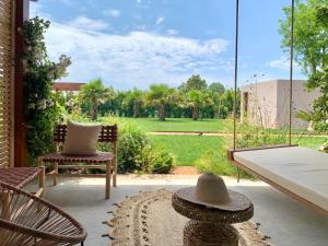 a patio with two chairs and a swing at Santa Lucia Maccarese - Residenza Agricola in Maccarese