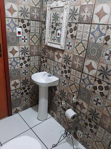 a bathroom with a sink and a mirror and tiles at Hospedaria e Hostel da Déia in Ouro Preto +27 photos