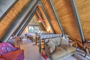a attic room with a bed and a couch at Irwin A-Frame Cabin with Deck and Mountain Views! in Irwin