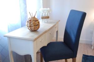 a desk with a blue chair and a pineapple on it at Atlantic Town 2 - Free Parking in Ponta Delgada +20 photos
