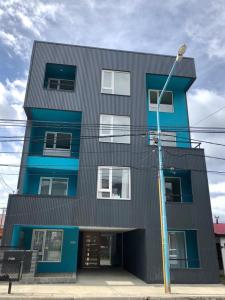 a black and blue building with a street light at Penguins Flats 4 in Ushuaia