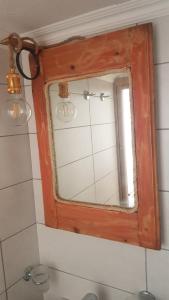a mirror above a sink in a bathroom at Margarita's Rooms in Chora Folegandros