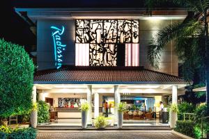 a building with a sign on the side of it at Radisson Goa Candolim in Candolim