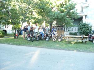 a group of people standing next to a group of motorcycles at Aunt Jane's Victorian Manor in Put-in-Bay