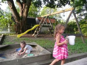 two young children playing in a sandbox in a sandbox at Aunt Jane's Victorian Manor in Put-in-Bay