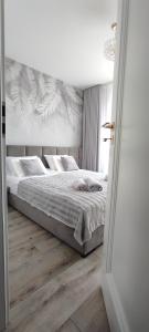Posteľ alebo postele v izbe v ubytovaní Apartament Złote Noce
