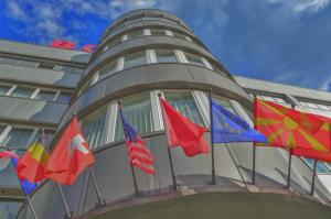 a group of flags on the side of a building at Hotel & Resort Bon Bon in Skopje