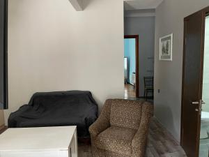 a bedroom with a bed and a chair and a table at Batumi Summer Hotel in Batumi