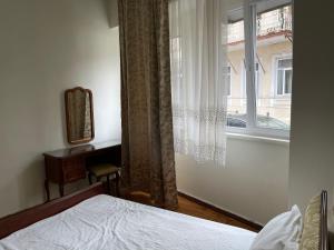 a bedroom with a bed and a window at Batumi Summer Hotel in Batumi