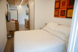 a bedroom with a white bed and a desk at ComoLakeHouse in Como