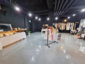 a clothing store with clothes on racks in a room at Villae Resort in Jeju