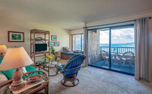 a living room with a view of the ocean at Sealodge E8-oceanfront views near secluded beach, with wifi and pool in Princeville