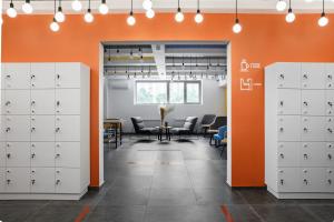 an office with white lockers and a orange wall at Luna in Vladivostok