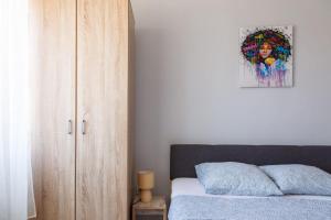 a bedroom with a bed and a wooden cabinet at Aloha - Sobe sa kupatilom in Golubac
