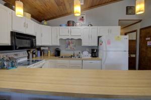 a kitchen with white cabinets and a white refrigerator at 117 Fourth St, Bethany Beach in Bethany Beach +28 photos
