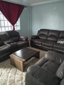 a living room with a couch and a coffee table at Alken Homes - Two Bedroomed, Naivasha in Naivasha