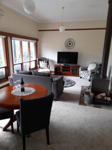 a living room with a couch and a table at Archery Road Estate in Rowland Flat