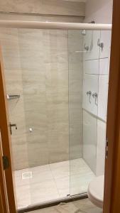a glass shower in a bathroom with a toilet at SALINAS PARK RESORT in Salinópolis