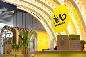 a store with a yellow sign in a building at YELLO Hotel Kuta Beachwalk Bali in Kuta